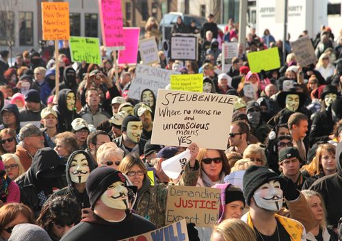 People protest at the Jefferson County Courthouse in Steubenville, Ohio, in January 2013. Some are wearing masks associated with hoacking collective Anonymous, who leaked a damning video, images, emails and other information about the crime.