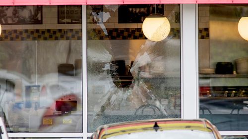 A shattered window at the scene of the shooting. (AP)