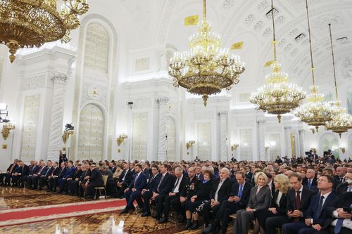 Participants listen to Russian President Vladimir Putin during celebrations marking the incorporation of regions of Ukraine to join Russia in the Kremlin in Moscow, Russia, Friday, Sept. 30, 2022. 