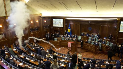 The Kosovo parliament was halted yesterday during a vote on a proposed border demarcation law after the opposition used tear gas. Picture: AAP.