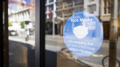 A sign on the display alerts the public to the requirements of face masks. 