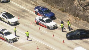 A black Mercedes crashed into two police cars on the M1.