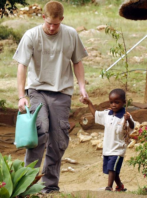 Prince Harry with Mutsu Potsane, age 4.  The 2004 trip inspired him to set up his charity Sentebale to help the land-locked nation's vulnerable children. (AAP)