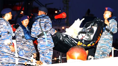 Rescuers in inflatable boats have retrieved human remains, pieces of aircraft and personal belongings from the crash scene.