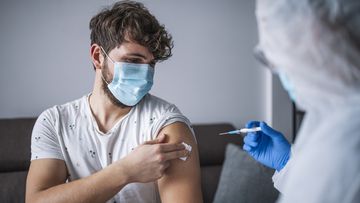 Man getting vaccinated. Vaccine. Needle