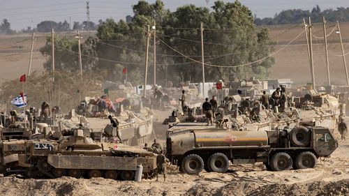     Os militares israelenses organizam o equipamento militar em pé nos braços dos transportadores de pessoal pelo termo Strip Gaza.