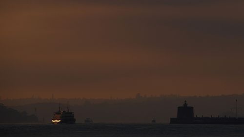 A Sydney ferry hidden by the thick smoke this morning. (AAP)