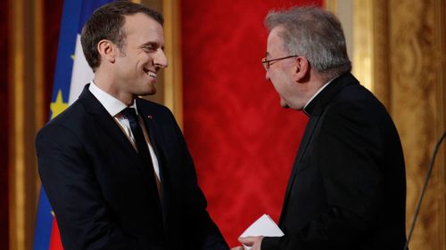 A file photograph shows French President Emmanuel Macron greeting Luigi Ventura in France.
