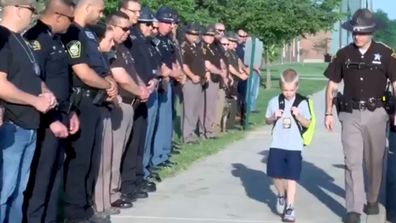 70 Indiana Police Officer formed a guard of honour for boy whose father was killed in the line of duty. (BBC)