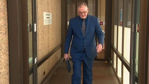 Journalist Hedley Thomas leaving murder trial of Chris Dawson.