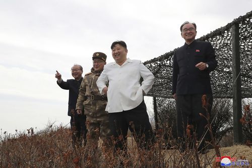 In this photo provided by the North Korean government, North Korean leader Kim Jong Un, second right, supervises what it says a test launch of a Hwasal strategic cruise missile during an exercise in North Korea Wednesday, March 22, 2023.  