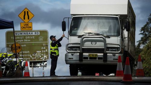 Commuters are stopped by police at the Queensland - NSW border checkpoint in the Gold Coast hinterland at Nerang Murwillumbah Road.