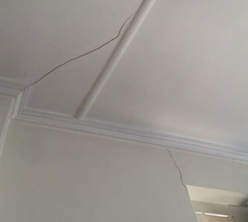 The cracks on the ceiling and wall of the apartment. (Angeline Darling)