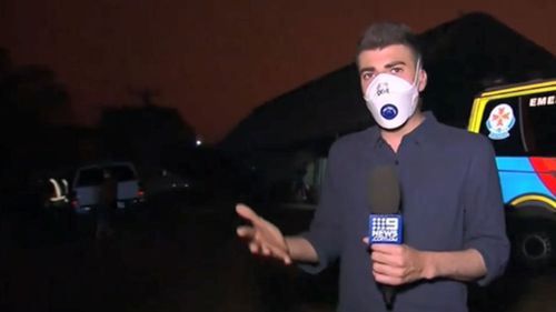 9News reporter Sam Cucchiara broadcasts after Mallacoota was once again plunged into darkness.