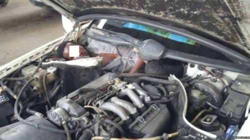 West African migrant found hiding behind car engine