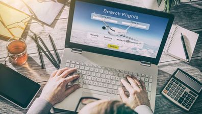 Person booking flights on computer