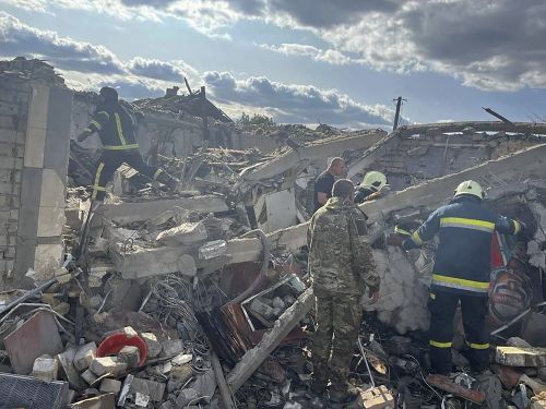 In this photo provided by the Ukrainian Presidential Press Office, emergency workers search the victims of a Russian rocket attack that killed at least 47 people in the village of Hroza near Kharkiv, Ukraine, Thursday, Oct. 5, 2023.