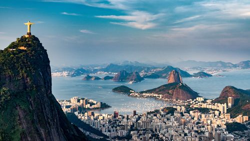 Aerial view of Rio De Janeiro. Corcovado mountain with statue of Christ the Redeemer, urban areas of Botafogo and Centro, Sugarloaf mountain.