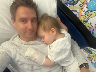 Mia Rose Steffe snuggles up to dad Daniel in hospital during cancer treatment.