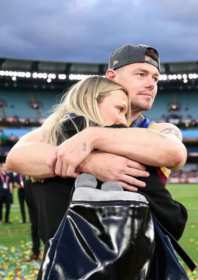 MELBOURNE, AUSTRALIA - SEPTEMBER 27: Lachie Neale of the Lions shares a moment with his wife Jules Neale after winning the AFL Grand Final match between Geelong Cats and Brisbane Lions at Melbourne Cricket Ground on September 27, 2025 in Melbourne, Australia. (Photo by Cameron Spencer/AFL Photos/via Getty Images)