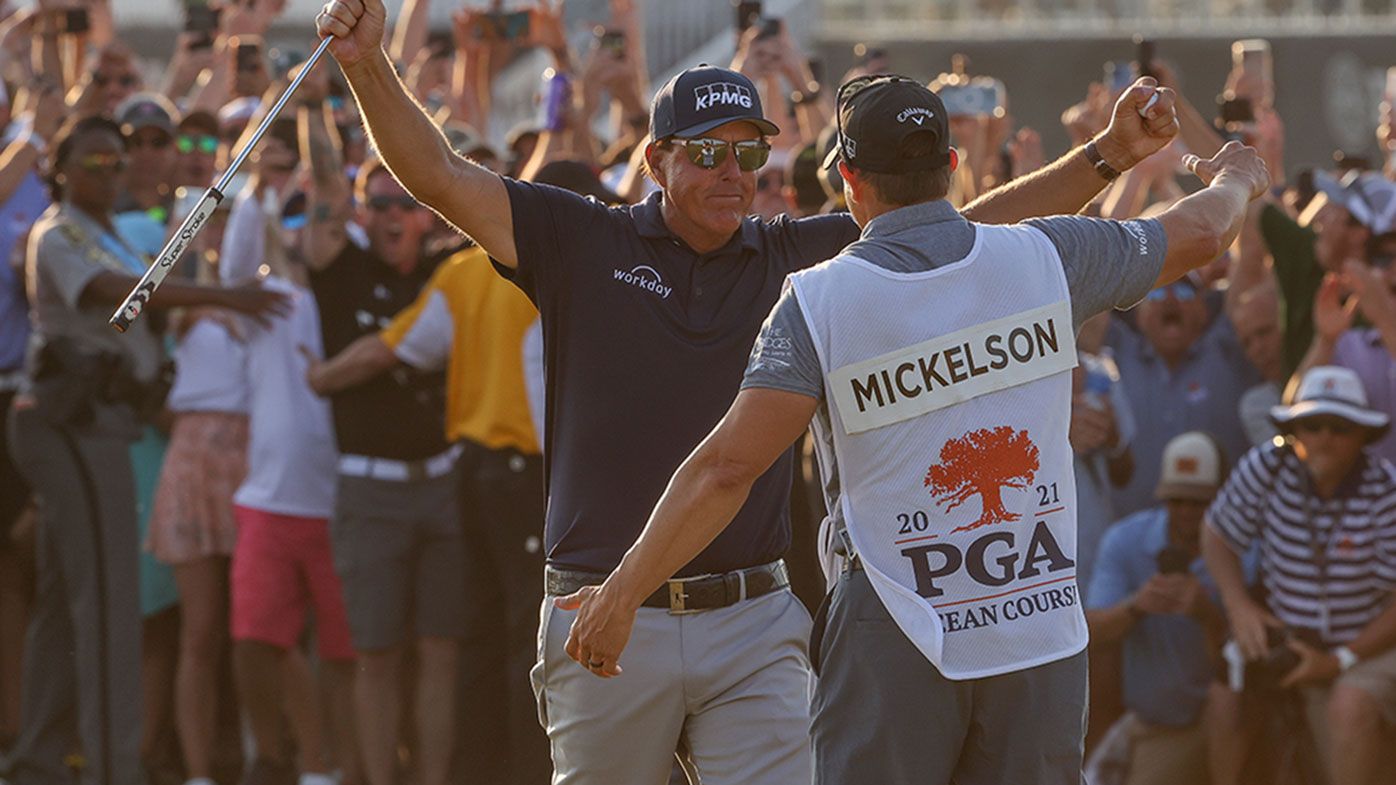 Phil Mickelson celebrates with brother and caddie Tim Mickelson after winning the 2021 PGA Championship.