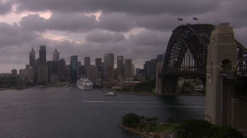 The sky darkens over Sydney's CBD. 