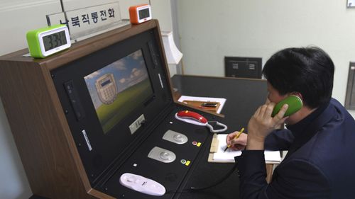 A South Korean official speaks to a North Korean officer on the newly reopened hotline. Photo: AAP