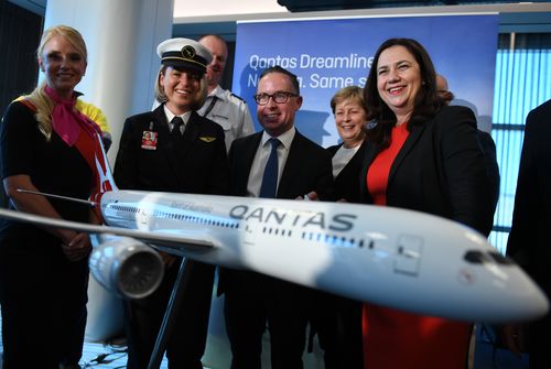 Queensland Premier Annastasia Palaszczuk (right) and Qantas Group CEO Alan Joyce (centre) pose for a photo after Qantas announced it will base four of its new 787-9 Dreamliner in Brisbane.