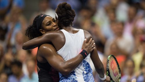 Serena and Venus Williams embrace after their women's singles quarter final match at the US Open. (AAP)