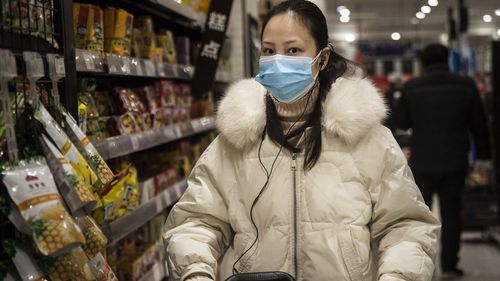 A woman wears a protective mask as she shops in the supermarket on in Wuhan, Hubei province, China. 