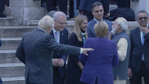 Scott Morrison speaking with UK Prime Minister Boris Johnson during a world leaders photo call in Rome.