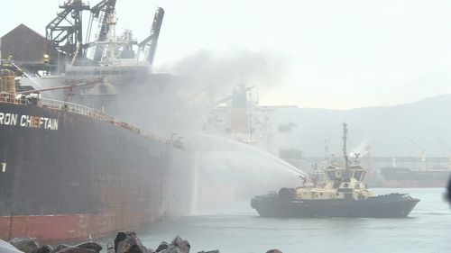 An iron ore carrier has caught alight in Port Kembla Harbour. Picture: Nine