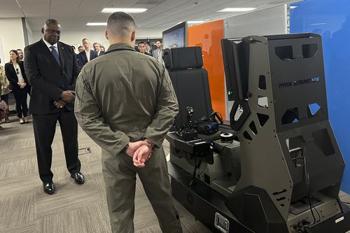 Defence Secretary Lloyd Austin watches a demonstration of a virtual training device that will help Ukrainian pilots learn to fly F-16 fighter jets during a tour of the Pentagon's Defense Innovation Unit in Mountain View, Calif, on Friday, Dec. 1, 2023