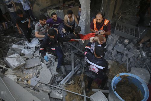 Palestinians rescue wounded in Israeli airstrike on the Haboush family building in Gaza City, Gaza Strip, Wednesday, Oct. 18, 2023. 