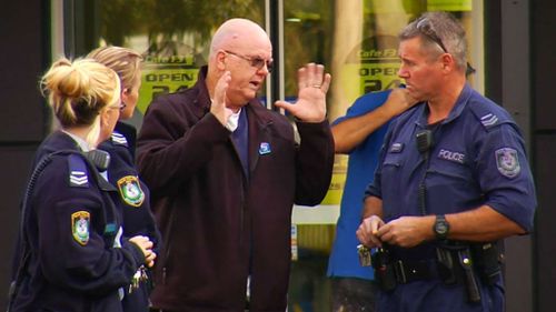 Police speak to the victim of an alleged carjacking in Sydney this morning.