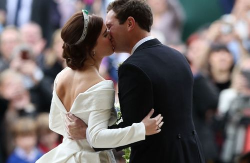 Princess Eugenie and Jack Brooksbank share a shy kiss on the steps of St George's Chapel.