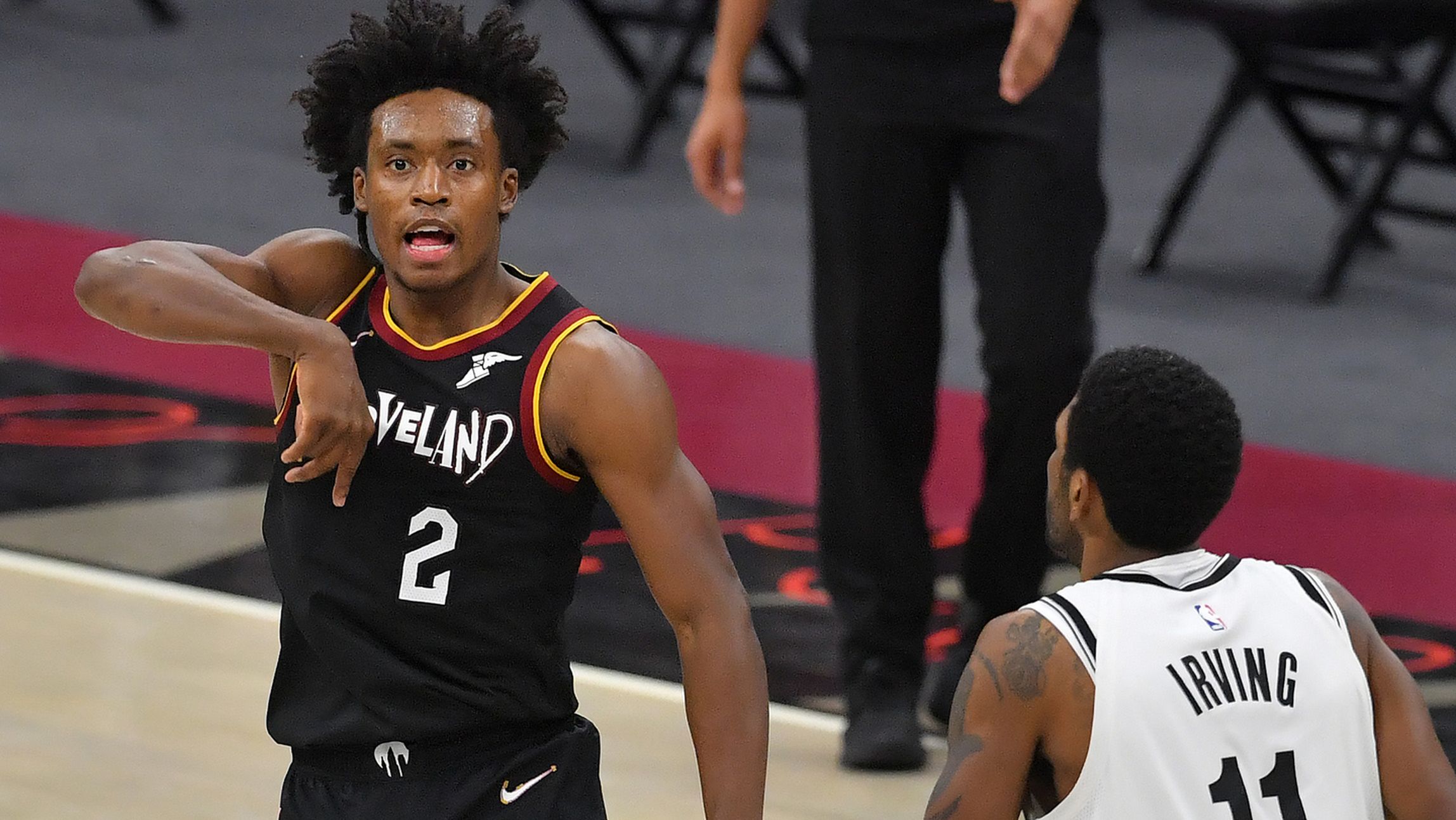 Kyrie Irving of the Brooklyn Nets watches as Collin Sexton of the Cleveland Cavaliers celebrates.