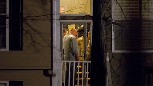 Detectives inside a home near Atlanta, Georgia where the bodies of five people were found. (AAP)