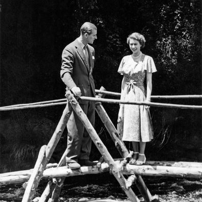 Princess Elizabeth and the Duke of Edinburgh on a bridge in the grounds of Sagana Lodge, their wedding present from the people of Kenya, 5th February 1952. The following day, news would arrive of the death of King George VI and Elizabeth's accession to the throne. (Photo by NCJ Archive/Mirrorpix/Mirrorpix via Getty Images)