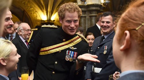 Prince Harry speaking with armed forces personnel after an Afghanistan war commemoration. (AAP)