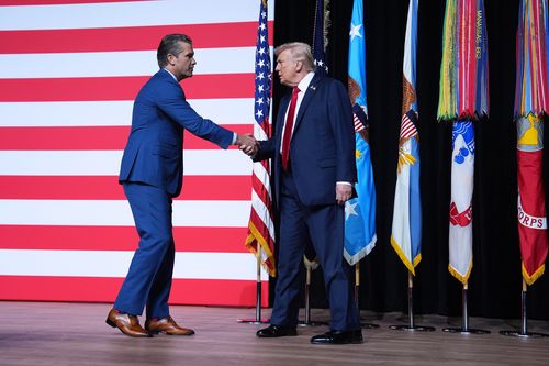 US President Donald Trump is greeted by US Secretary of Defence Pete Hegseth