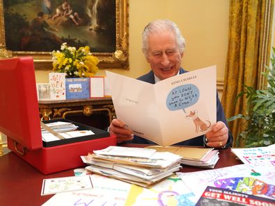In this photo released on February 23, King Charles III reads cards and messages, sent by well-wishers following his cancer diagnosis, in the 18th Century Room of the Belgian Suite at Buckingham Palace on February 21, 2024 in London, England.