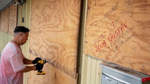 Bang Bui prepares his business Handy Mart as Hurricane Delta approaches in Abbeville, Louisiana.