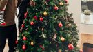 Family decorating a Christmas tree. 