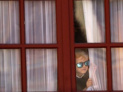 The cheeky royal spied on the proceedings from above through a window overlooking the courtyard. 