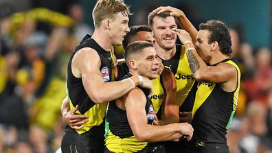 Dion Prestia of the Tigers celebrates kicking a goal with team mates during the 2020 AFL Grand Final