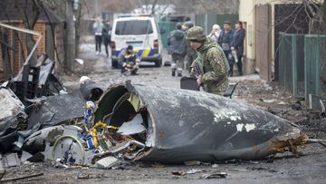 A Ukrainian Army soldier inspects fragments of a downed aircraft in Kyiv, Ukraine.