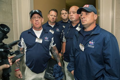 Sept. 11 first responders John Feal, left, Ret. Lt. Michael O'Connell, right, and other first responders speak to reporters as they leave the office of Senate Majority Leader Mitch McConnell.