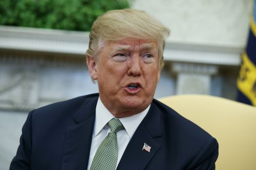 In this March 15, 2018, file photo, President Donald Trump talks with reporters during a meeting in the Oval Office of the White House in Washington. Trump is questioning the impartiality of Robert Mueller's investigation and says the probe is groundless, while raising doubts about whether a fired top FBI official kept personal memos outlining his interactions with Trump. (AP Photo/Evan Vucci, File)