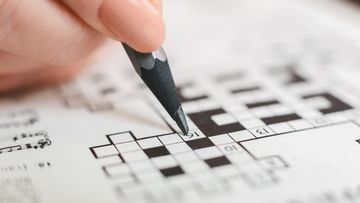 woman completing crossword